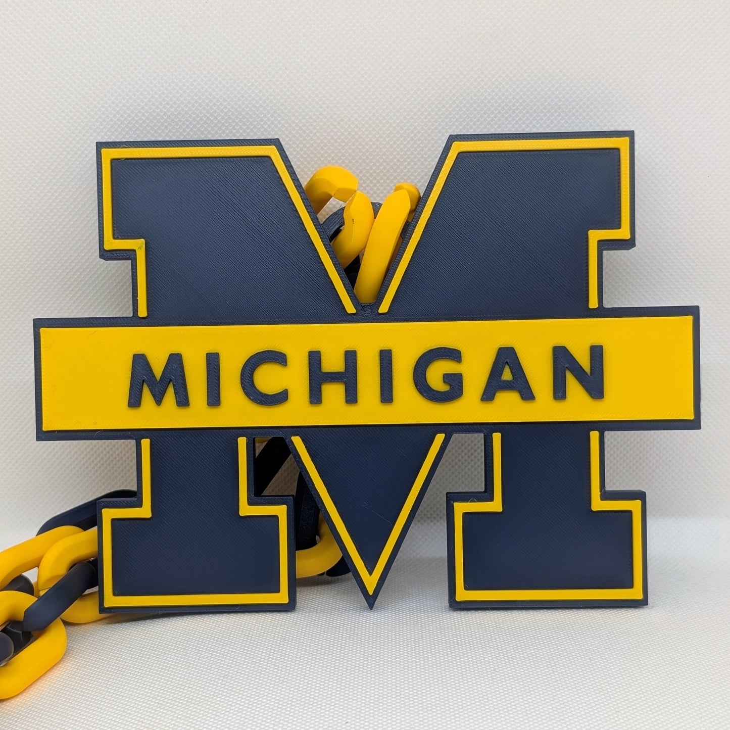 Michigan logo with yellow and blue colors on a white background