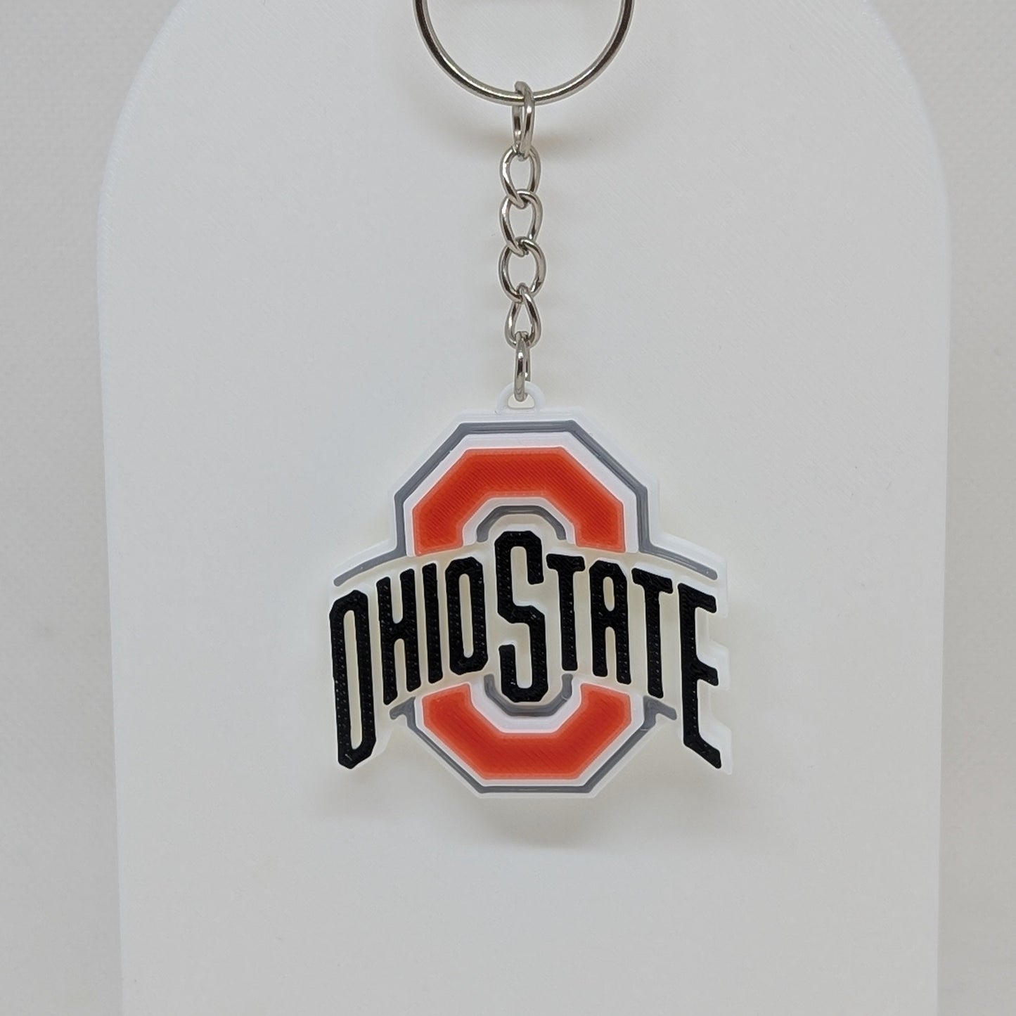 Ohio State keychain on a white display stand