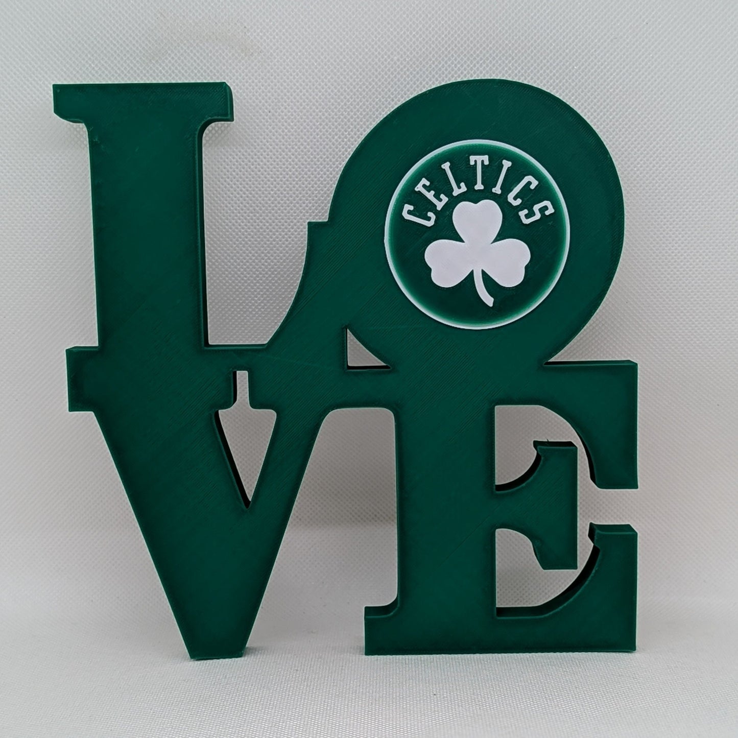 Celtics Green 'LOVE' sign with Celtics logo on a white background