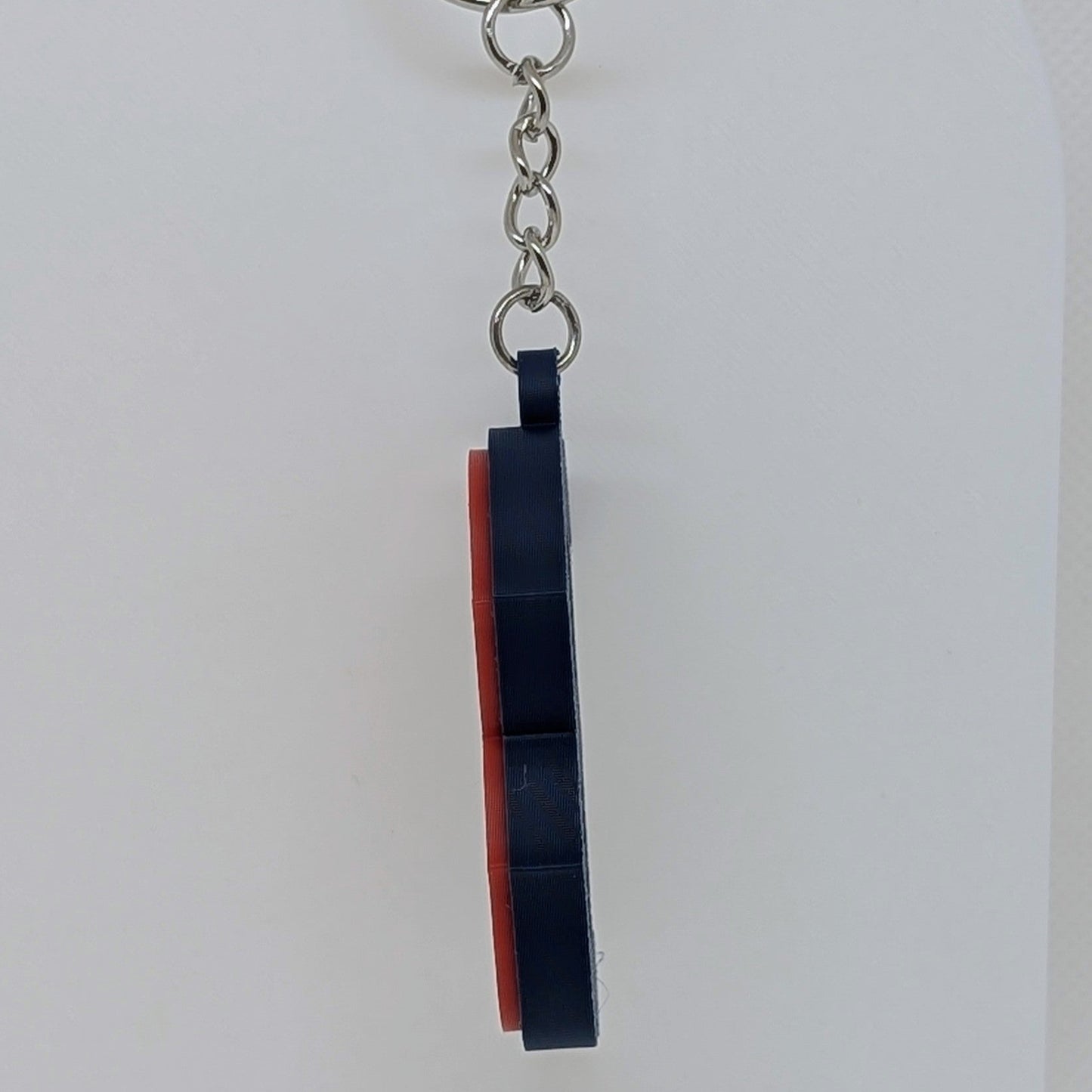 Keychain with a black and red design on a white background