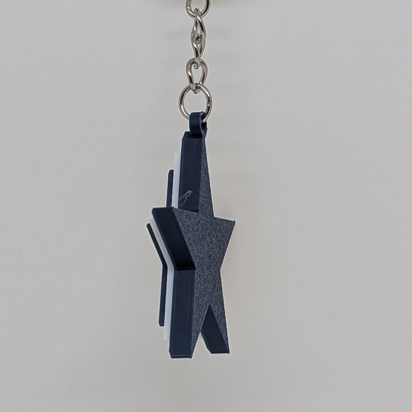 Keychain with a unique design on a white stand against a white background