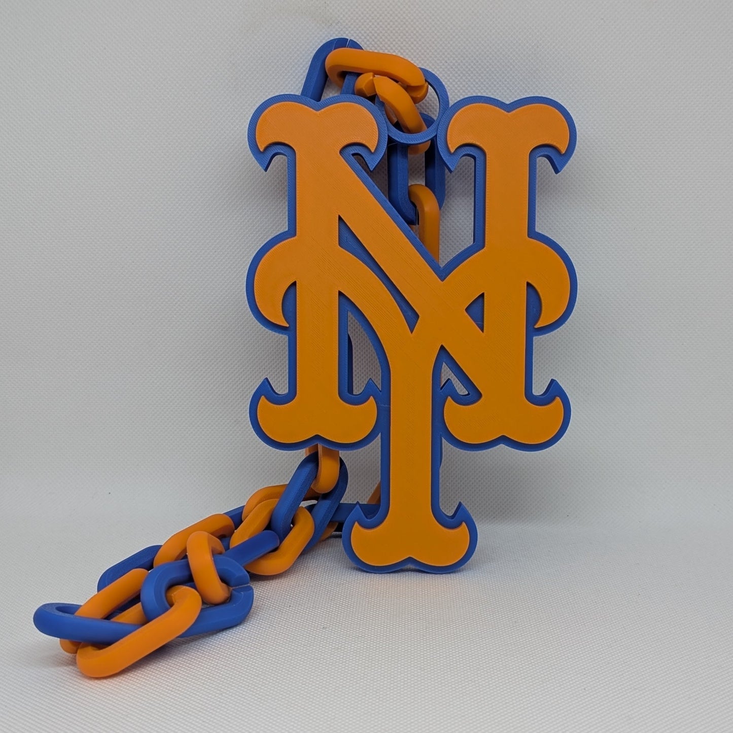 Mets chain with orange and blue 'M' logo on a white background