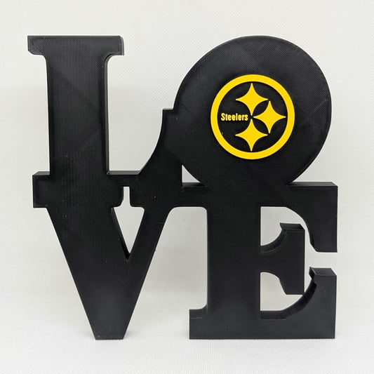 Black 'LOVE' sculpture with a Steelers logo on a white background