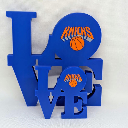 Blue 'LOVE' decorative sign with New York Knicks logo on a white background