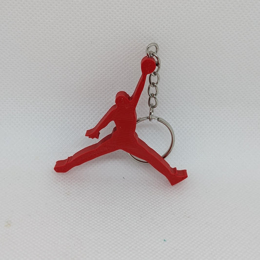 Red keychain with a figure on a white background