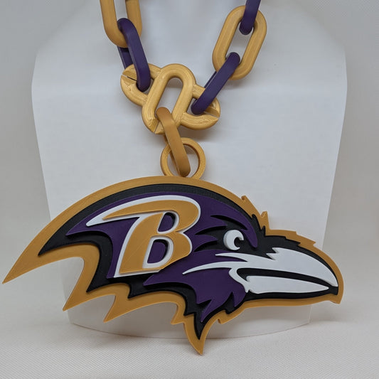 Baltimore Ravens logo keychain on a white stand