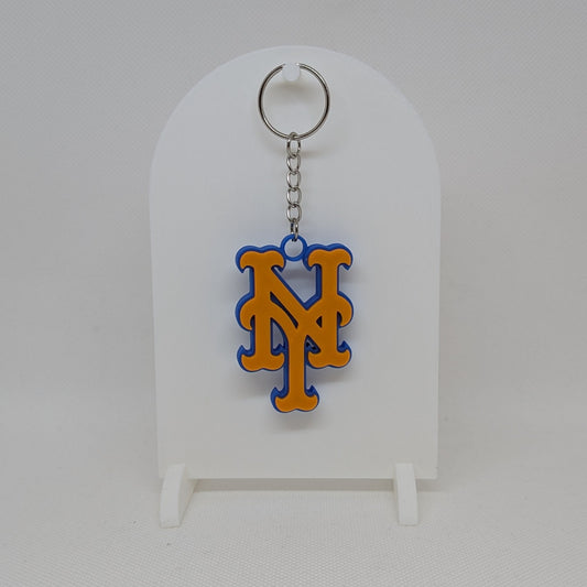 Mets Keychain with a logo on a white stand against a white background