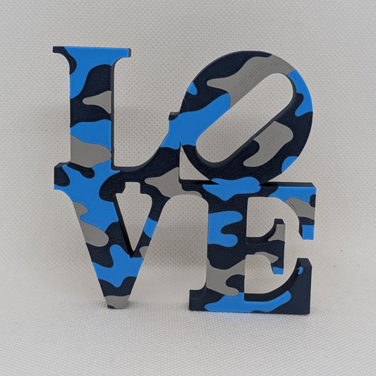 Navy camouflage-style 'LOVE' letter set on a light gray background