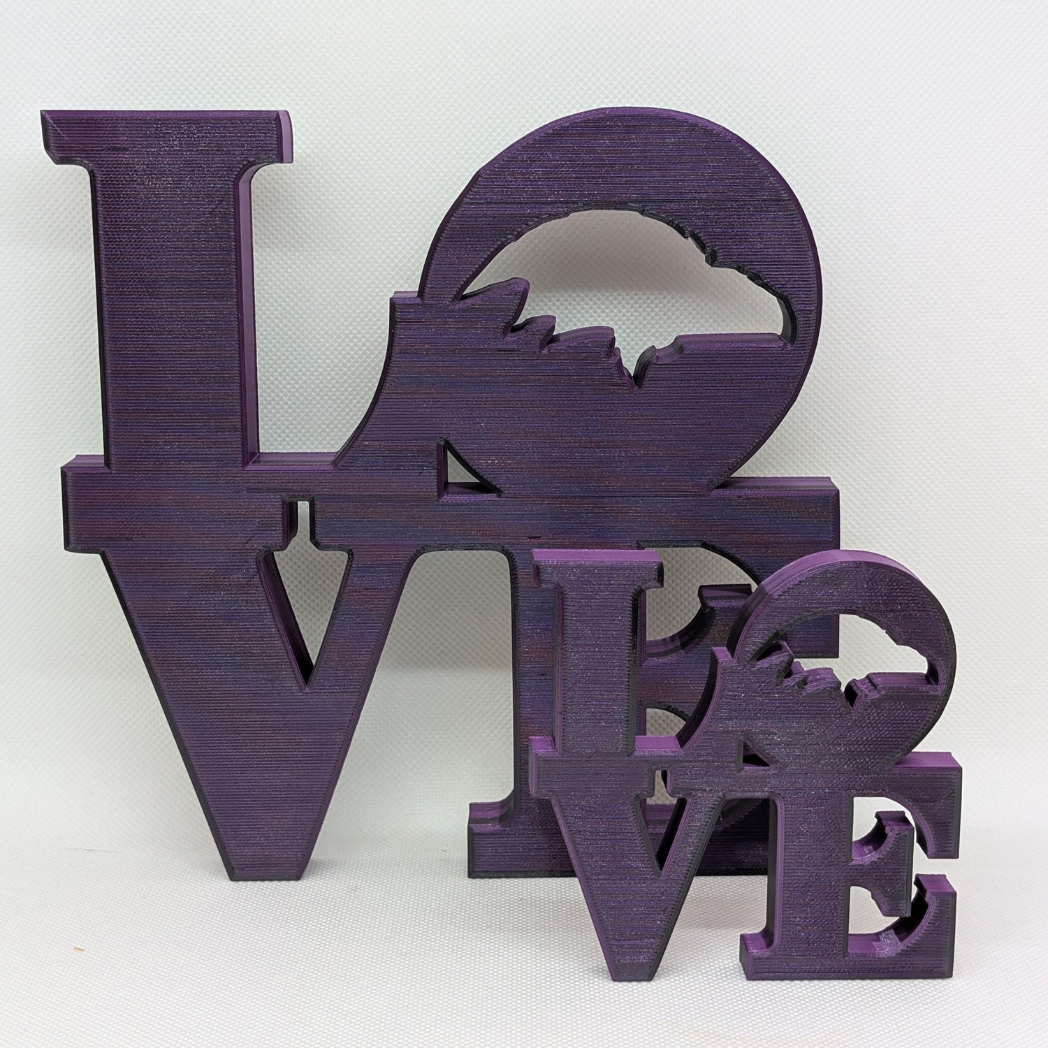 Purple 'LOVE' decorative letters on a white background