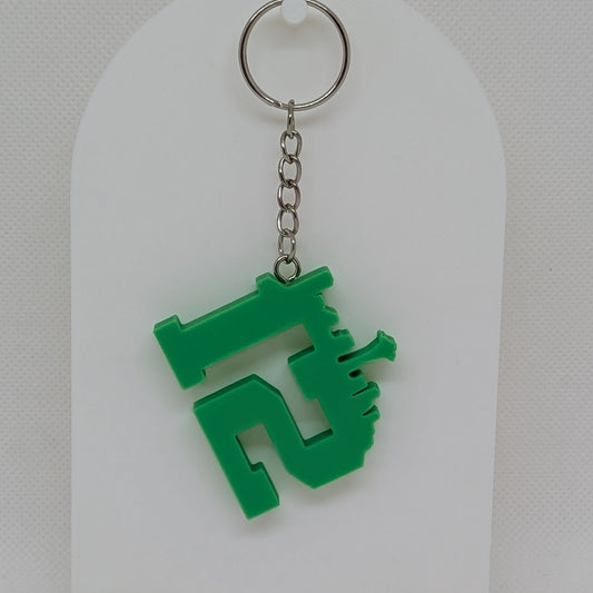Seahawks Green keychain on a white stand against a light gray background