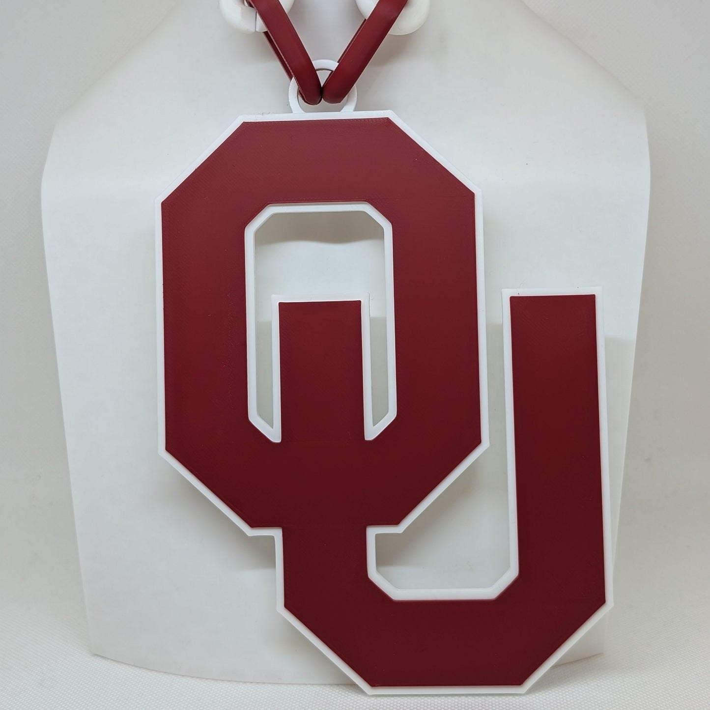 White paper bag with a red 'OU' logo on a white background