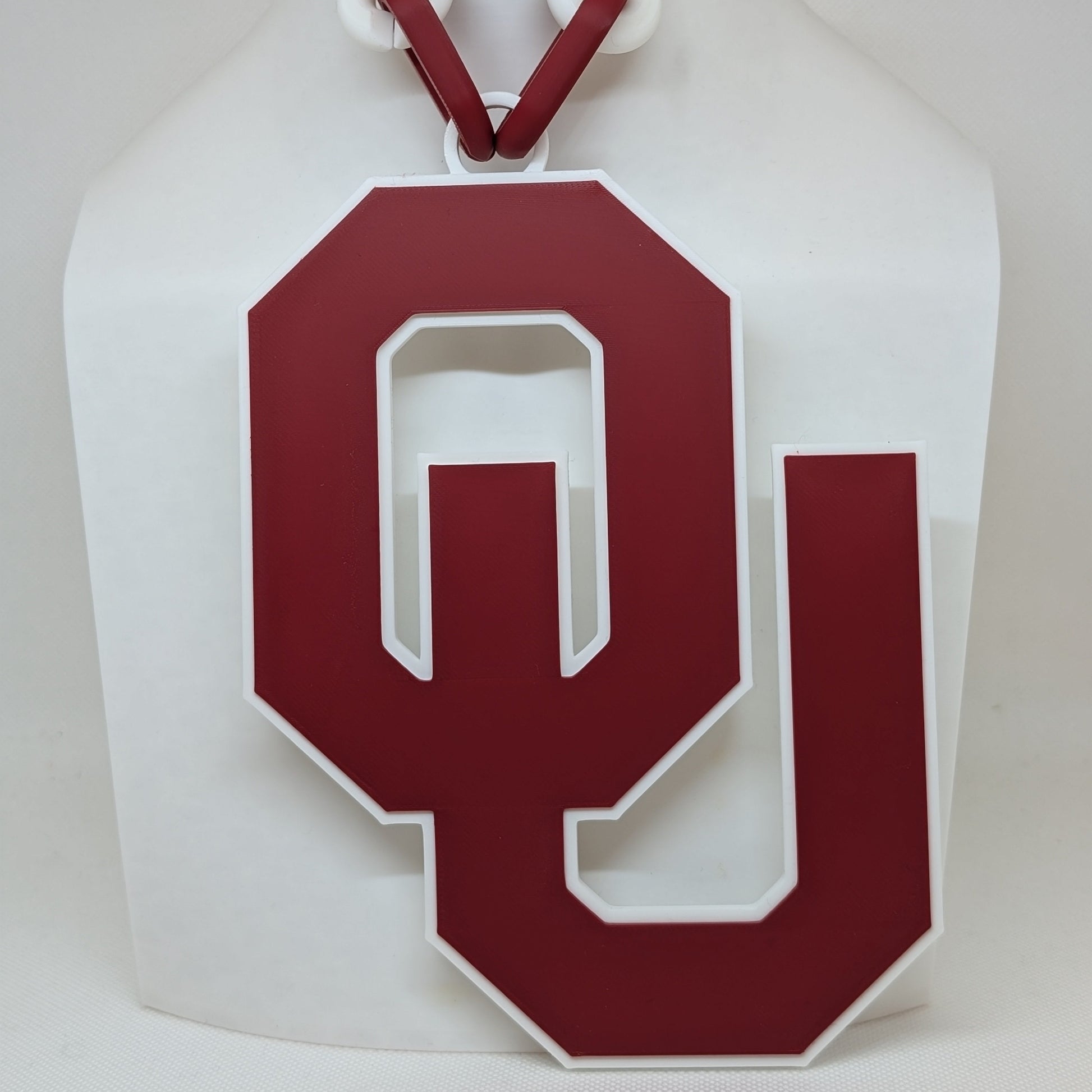 White paper bag with a red 'OU' logo on a white background