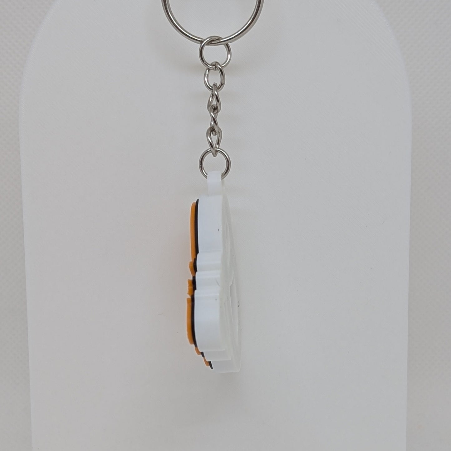 Keychain with a white and brown design on a white background