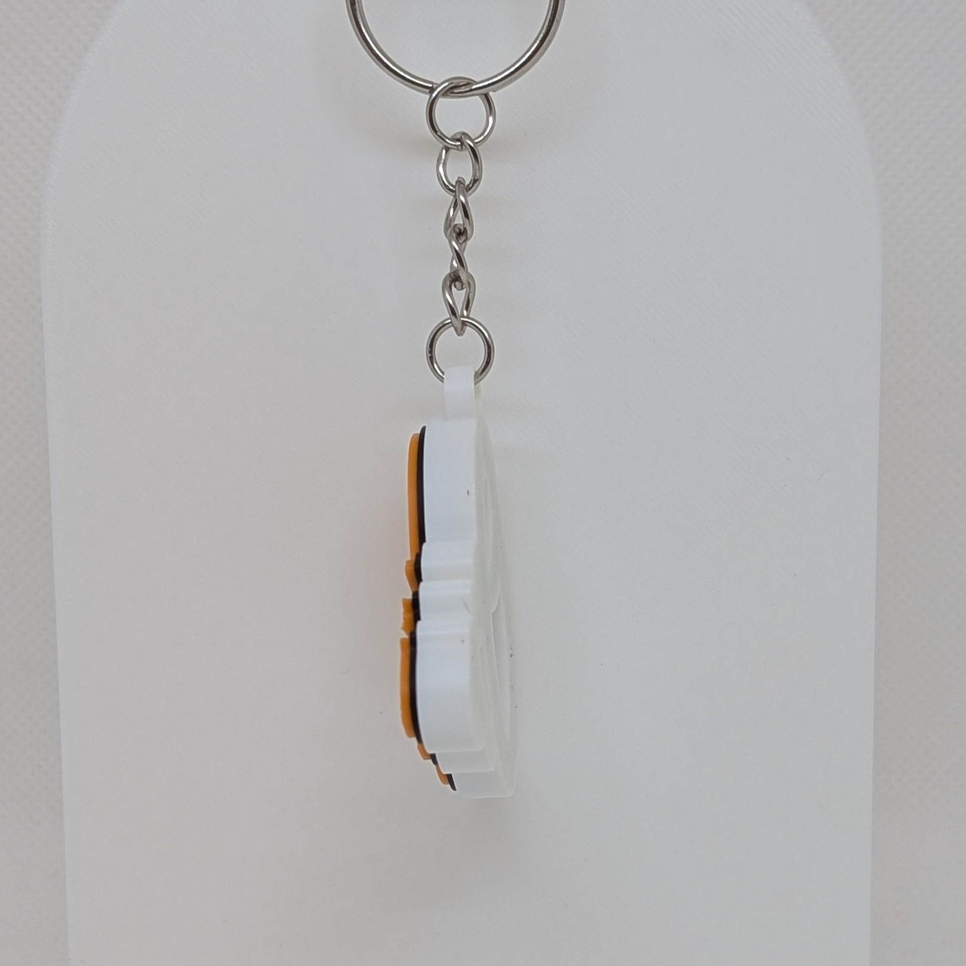 Keychain with a white and brown design on a white background