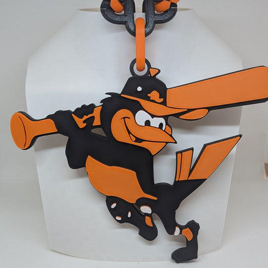 Orioles character with an orange bat in a white box