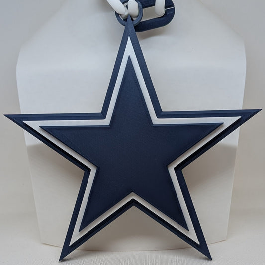 Cowboys Blue star-shaped tag with white string on a white background