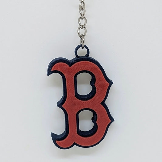 Keychain with a red 'B' logo on a white background