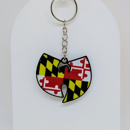 Wu-Tang Keychain with a colorful design on a white stand