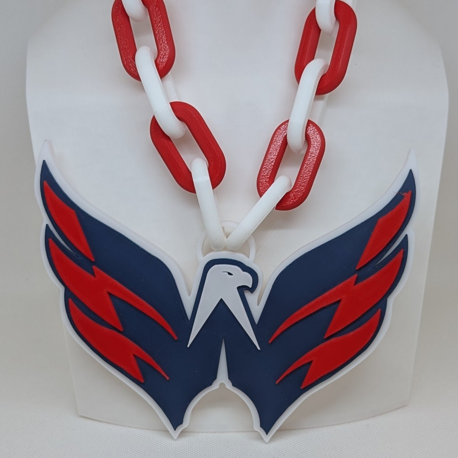Capitals with red and blue design on a white background