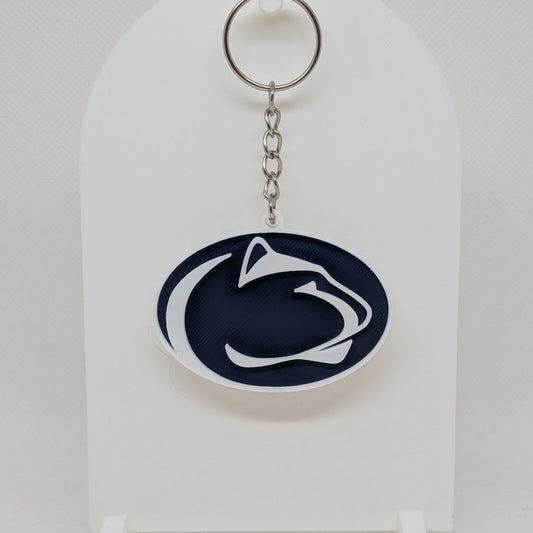 Penn State Keychain with a logo on a white stand against a white background